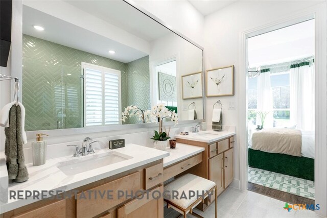 225 Dycus Bnd, Liberty Hill, TX 78642 - full bath with double vanity, healthy amount of natural light, a shower stall, tile patterned floors, and recessed lighting