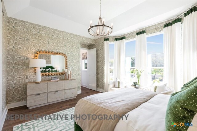 225 Dycus Bnd, Liberty Hill, TX 78642 - bedroom featuring a chandelier, dark wood-style flooring, baseboards, and wallpapered walls