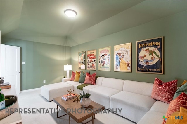 225 Dycus Bnd, Liberty Hill, TX 78642 - carpeted living room featuring vaulted ceiling and baseboards