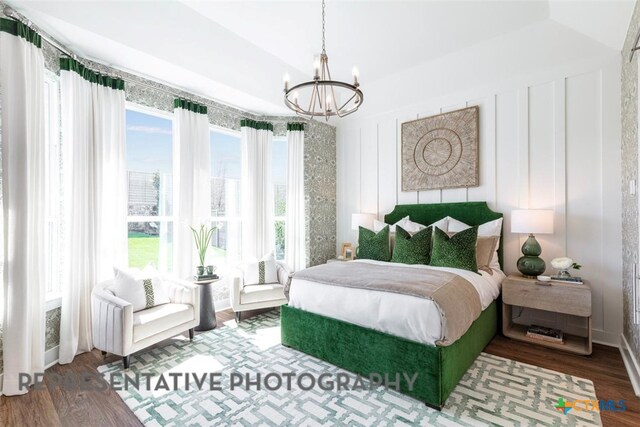 225 Dycus Bnd, Liberty Hill, TX 78642 - bedroom featuring a chandelier and wood finished floors