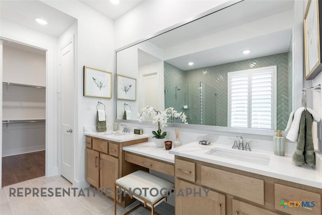 225 Dycus Bnd, Liberty Hill, TX 78642 - bathroom featuring a shower stall, vanity, a spacious closet, tile patterned flooring, and recessed lighting