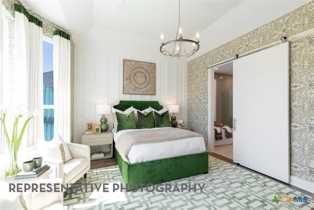 225 Dycus Bnd, Liberty Hill, TX 78642 - bedroom with a chandelier, wallpapered walls, and a barn door