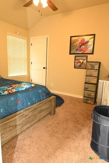 bedroom with carpet, vaulted ceiling, baseboards, and a ceiling fan