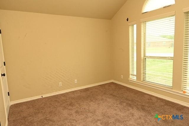 unfurnished room featuring baseboards, carpet floors, and vaulted ceiling