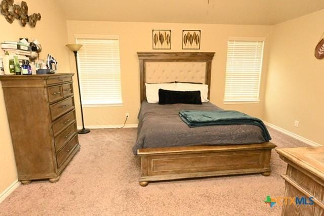 bedroom featuring carpet and baseboards