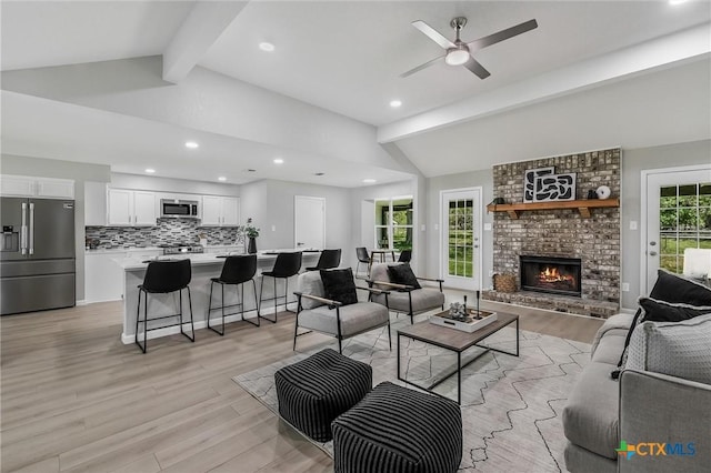 1070 Lonesome Trl, Driftwood, TX 78619 - living room featuring light wood-style flooring, a ceiling fan, a fireplace, and recessed lighting