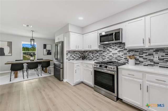 1070 Lonesome Trl, Driftwood, TX 78619 - kitchen with stainless steel appliances, light countertops, white cabinetry, and recessed lighting