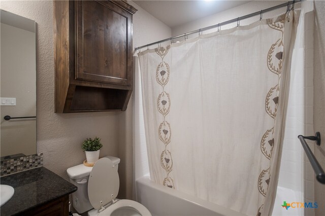 full bathroom featuring shower / bath combo, vanity, and toilet