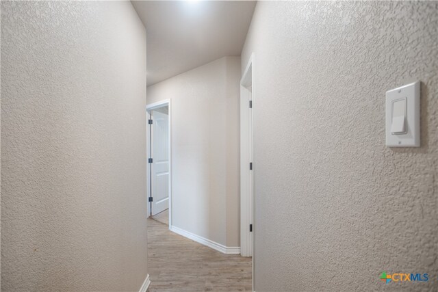 hallway with light hardwood / wood-style flooring