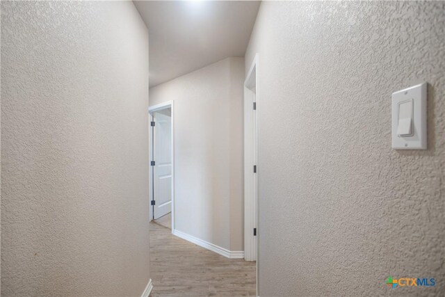 2520 Heartland Ave, Copperas Cove, TX 76522 - hall featuring wood finished floors, baseboards, and a textured wall