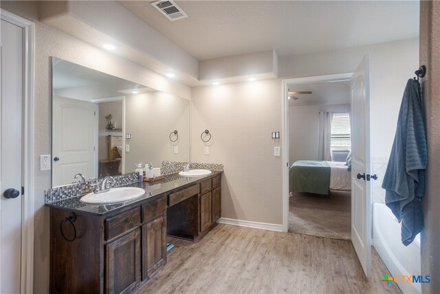 bathroom with vanity, hardwood / wood-style flooring, and ceiling fan