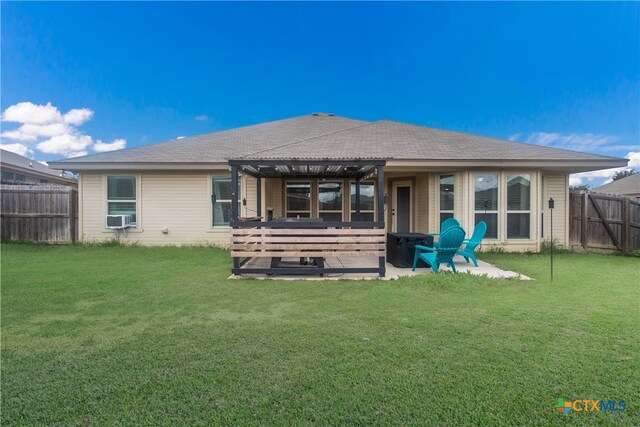 rear view of house featuring a lawn