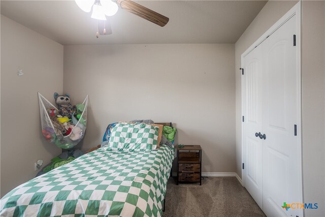 carpeted bedroom with ceiling fan and a closet