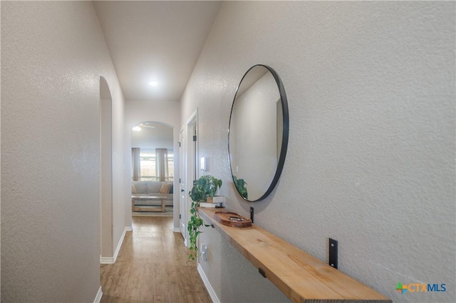 2520 Heartland Ave, Copperas Cove, TX 76522 - corridor with wood finished floors, arched walkways, a textured wall, and baseboards