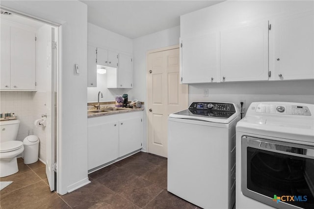 laundry room featuring a sink, separate washer and dryer, and laundry area
