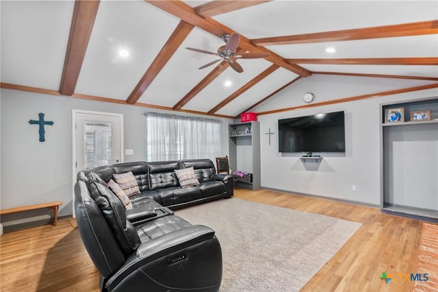 living area featuring baseboards, lofted ceiling with beams, a ceiling fan, and wood finished floors