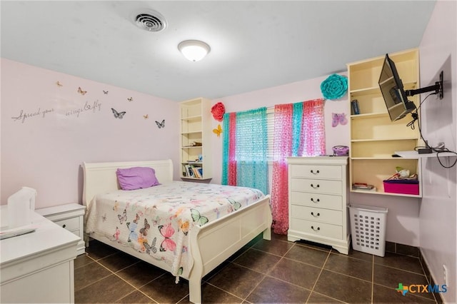 bedroom with visible vents and dark tile patterned floors