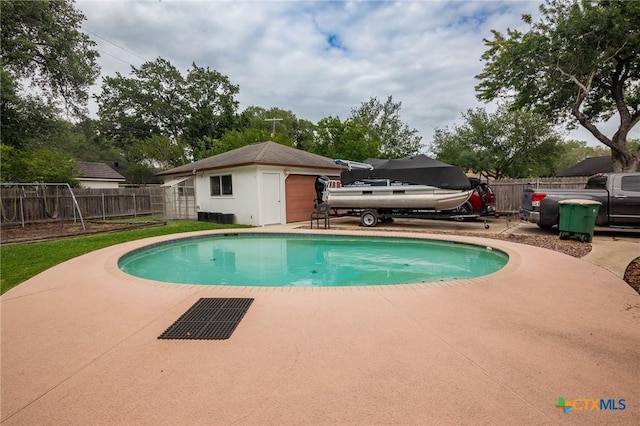 view of swimming pool with a fenced in pool, fence, and an outbuilding