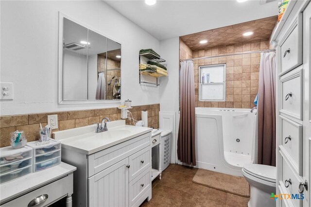 bathroom with recessed lighting, vanity, toilet, and visible vents