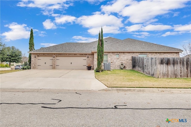 view of home's exterior with a yard, central AC unit, and a garage