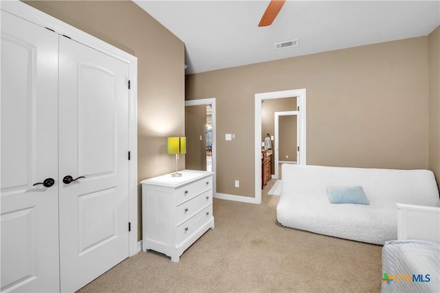 sitting room featuring ceiling fan and light colored carpet