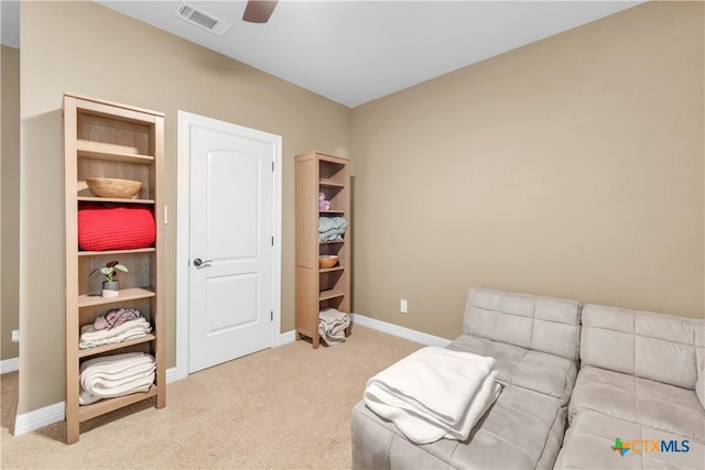 sitting room with ceiling fan and carpet floors