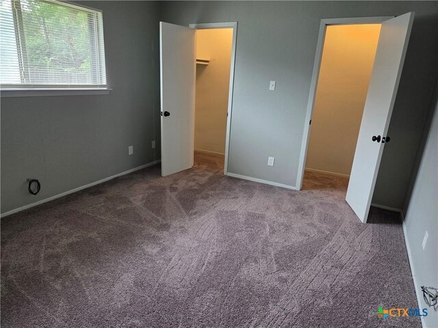 1805 Dickens Dr, Killeen, TX 76543 - unfurnished bedroom featuring a walk in closet, carpet flooring, and baseboards