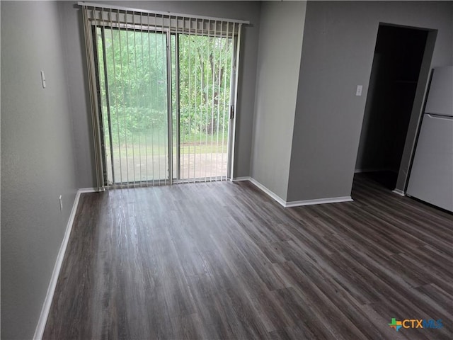 1805 Dickens Dr, Killeen, TX 76543 - spare room with dark wood-type flooring, plenty of natural light, and baseboards
