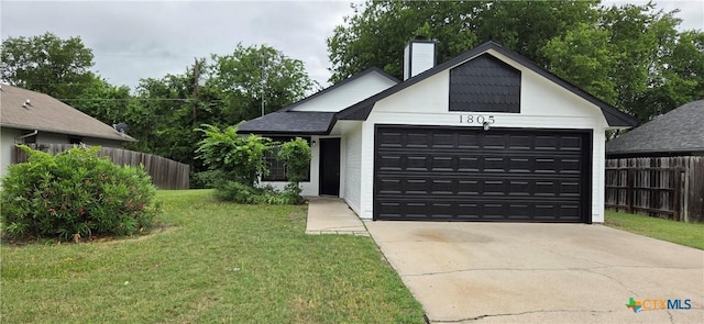 1805 Dickens Dr, Killeen, TX 76543 - view of front of home featuring a chimney, an attached garage, and driveway
