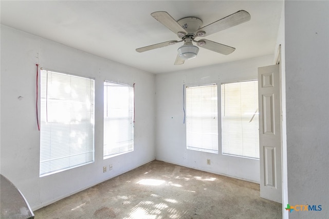 spare room with light carpet and ceiling fan