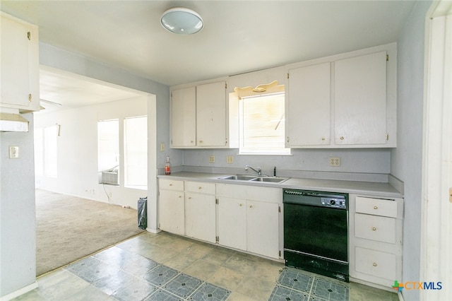 kitchen with dishwasher, light carpet, sink, and white cabinets