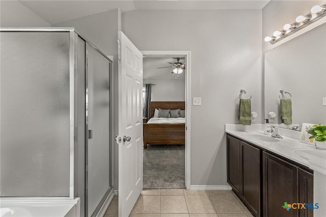 ensuite bathroom featuring ceiling fan, a stall shower, a sink, tile patterned floors, and connected bathroom