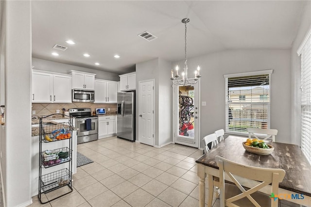 kitchen featuring plenty of natural light, stainless steel appliances, and visible vents