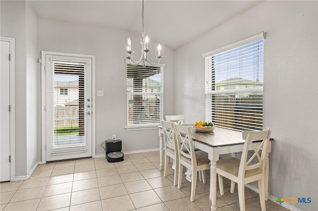 dining space with an inviting chandelier, baseboards, plenty of natural light, and light tile patterned floors