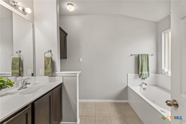 full bath featuring a bath, tile patterned flooring, vanity, baseboards, and lofted ceiling
