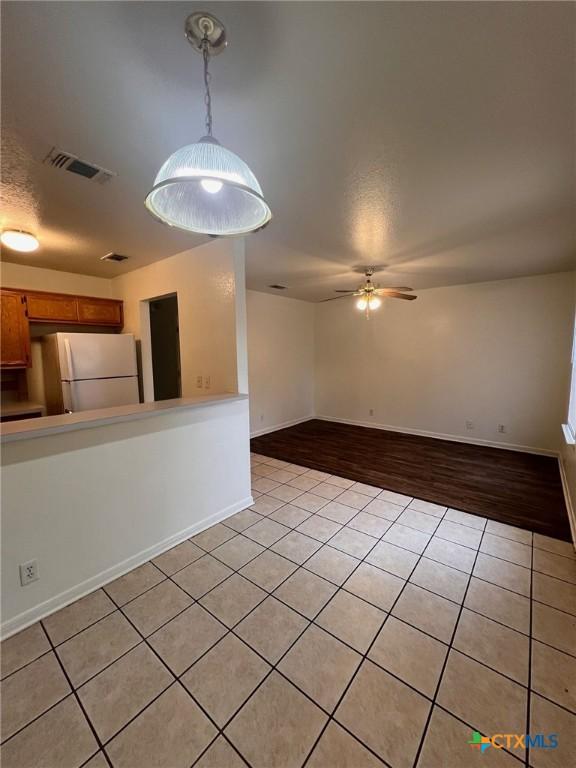 1402 Chips Dr, Killeen, TX 76549 - unfurnished room featuring light tile patterned floors, a ceiling fan, and baseboards