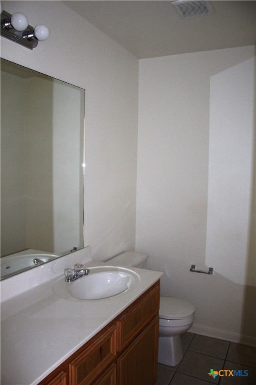 1402 Chips Dr, Killeen, TX 76549 - bathroom with tile patterned floors, vanity, and toilet