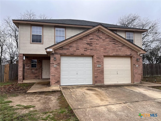 1402 Chips Dr, Killeen, TX 76549 - view of front of home with driveway, fence, brick siding, and a garage