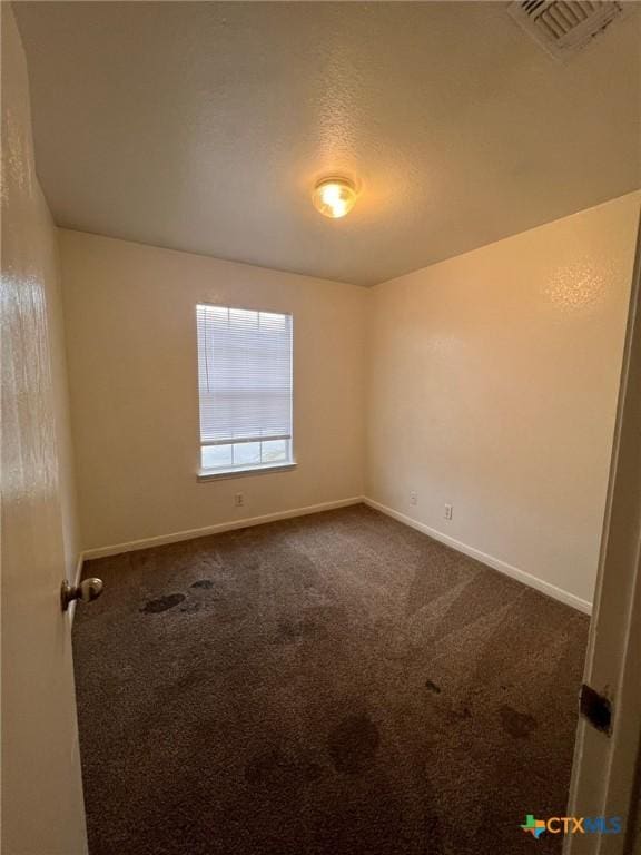 1402 Chips Dr, Killeen, TX 76549 - spare room with dark carpet and baseboards