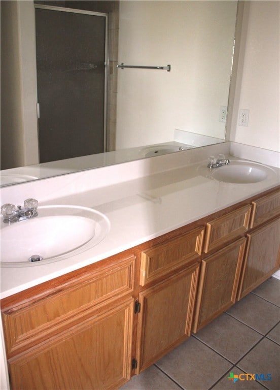 1402 Chips Dr, Killeen, TX 76549 - full bathroom with tile patterned flooring, double vanity, and a shower stall