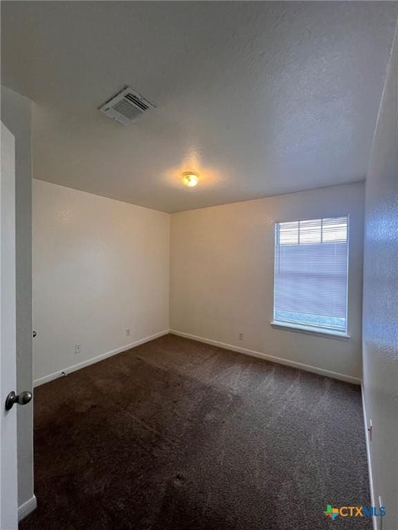 1402 Chips Dr, Killeen, TX 76549 - spare room featuring dark colored carpet and baseboards