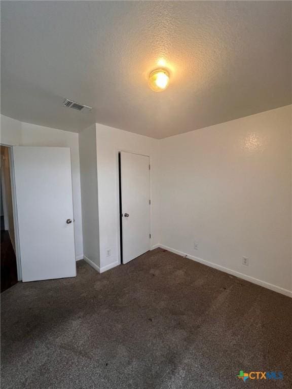 1402 Chips Dr, Killeen, TX 76549 - unfurnished bedroom featuring dark carpet and baseboards
