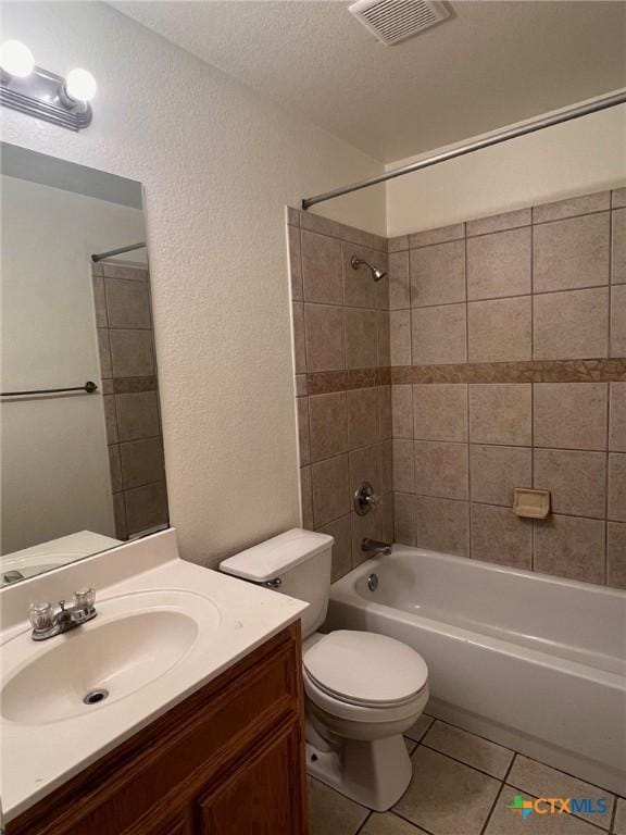 1402 Chips Dr, Killeen, TX 76549 - full bathroom with tile patterned flooring, a textured wall, washtub / shower combination, toilet, and vanity