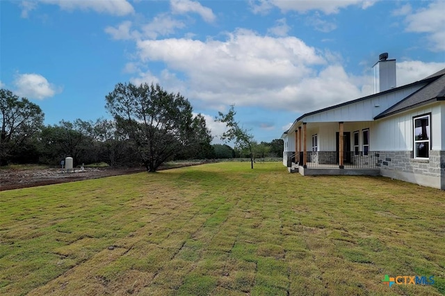 view of yard with covered porch