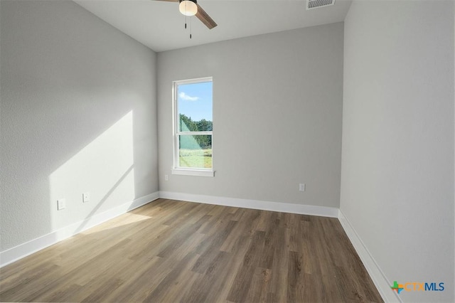 unfurnished room with hardwood / wood-style floors and ceiling fan