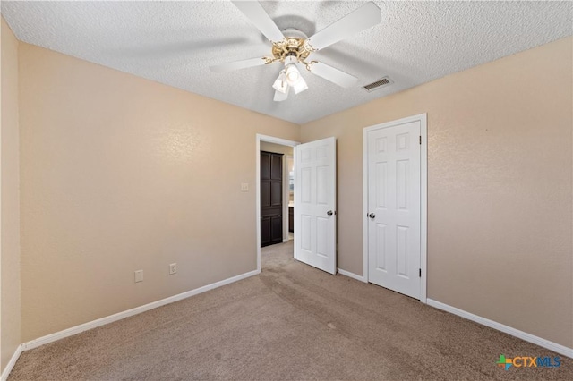 unfurnished bedroom featuring ceiling fan, a textured ceiling, and carpet floors