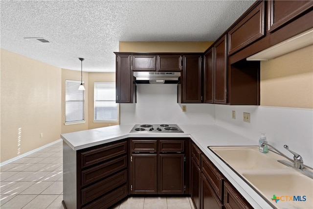 kitchen with light tile patterned floors, sink, pendant lighting, and white electric stovetop