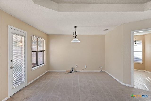 interior space with light colored carpet and a textured ceiling