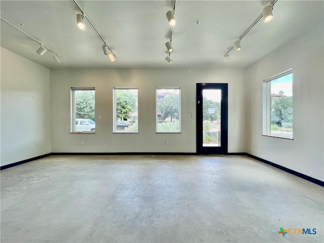 1905 Dutton Dr Unit A, San Marcos, TX 78666 - spare room featuring rail lighting, finished concrete floors, and plenty of natural light