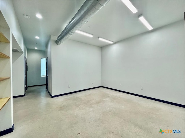 1905 Dutton Dr Unit A, San Marcos, TX 78666 - empty room featuring concrete flooring, baseboards, a smoke detector, and recessed lighting
